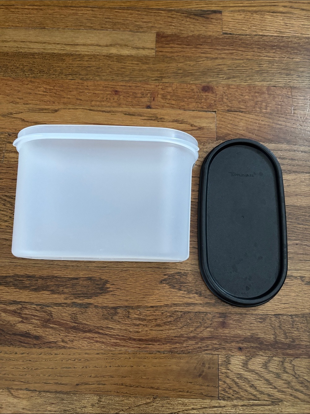 Tupperware size 2 oval with black lid